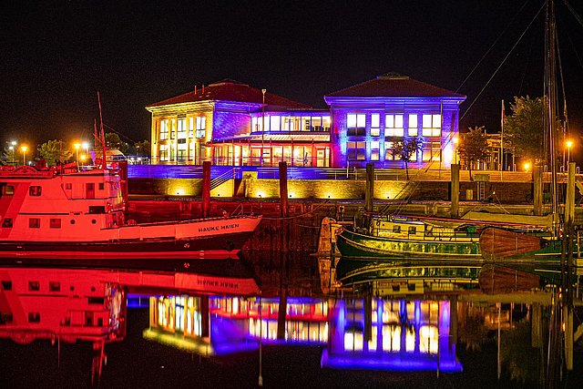 Das Reedereigebäude am Wyker Hafen erstrahlt in buntem Lichterglanz.